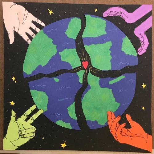 Work of student with colored hands holding a globe