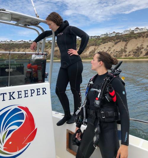 Two women scientists aboard research vessel on diving field work