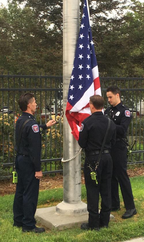 3 firefighters conduct flag raising