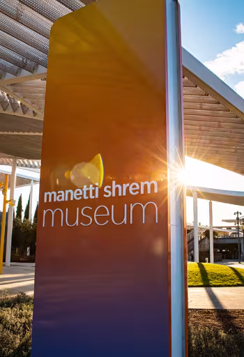 Photo of Manetti Shrem Museum in winter sunshine, showing orange and purple hues