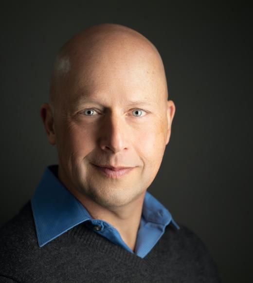 Man in blue shirt on dark background