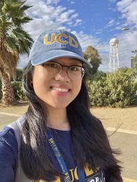 Ellaine Arroyo smiling on a sunny day wearing UC Davis merch