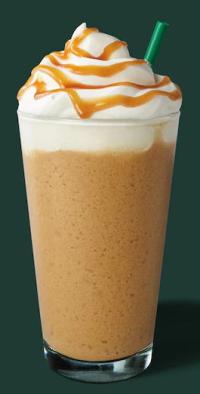 Starbucks coffee drink in glass, with whipped cream and straw