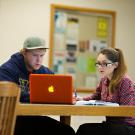 Two students work in front of a laptop at UC Davis.