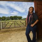 student standing in barn entrance
