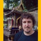 The author poses against backdrop of a small temple.