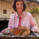 Christine Bruhn holding a roasted chicken