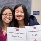 Two students from Davis Women in Business club pose with achievement certificates.