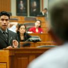 Miguel Zavala, participant in the King Hall Outreach Program, argues before a panel of judges in a mock courtroom