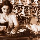 Woman works at sewing machine, from cover of "he Oxford Handbook of American Women&rsquo;s and Gender History."