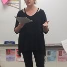 Woman standing and talking in elementary classroom