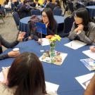 Wendy Chen &rsquo;17 (gesturing on left) to a table of students about being a consultant
