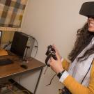 Communications graduate student Gracie Wolff wears a virtual reality headset to study the effects of role playing on public pers