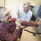 Gary Matteson, foreground, a researcher in biological and agricultural engineering, prepares to perform a radio check with members of the newly established amateur radio group at UC Davis. Listening in is John Berg, a lab manager in chemistry wh