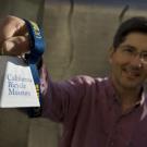 Cell biology researcher John Hess displays the California Bicycle Museum cowbell, made for the Amgen Tour of California.