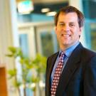 Man posing in a windowed foyer