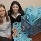 For the Victims Memorial Project next week, Shauna Stratton, left, and
Marisa Messier of the Campus Violence Prevention Program are collecting
paper ribbons inscribed with sexual as