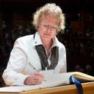 Photo: Vice Provost Maureen Stanton signs the Book of Members as part of her induction Oct. 6 into the American Academy of Arts and Sciences.