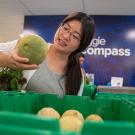 Female student selects melon at UC Davis' Aggie Compass