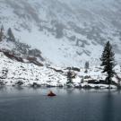 Scientist in boat on Emerald Lake during winter
