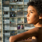 Boy with curly hair, on balcony