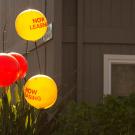 A bunch of balloons advertise an apartment for lease