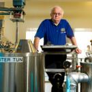 Charlie Bamforth stands amid brewery tanks.