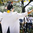 A student leads the Cal Aggie Marching Band-uh!