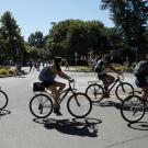 Students bike around a campus traffic circle