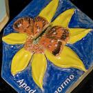 Photo: Tile showing a butterfly on top of a flower