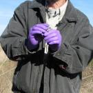 Photo: Walter Boyce in purple gloves talking, with dead mallard duck on table