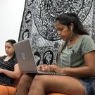 Students study while on a couch.