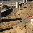 Conduit sticks out of ground for future charging stations.