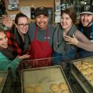 Photo: Coffee House managers all smiles beind the Swirlz bakery case.