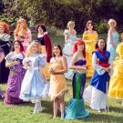 Fifteen women in coloful costumes