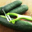 Three cucumbers with a peeler on top
