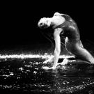Dancer in a pool of water, on stage