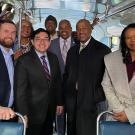 Chancellor Gary S. May amid group of people on historic bus