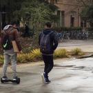 A student rides a hoverboard near Shields Library.