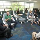 Visitors and international students and scholars sit in a semicircle.