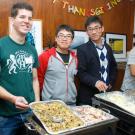Volunteers serve food during the International House's annual Thanksgiving dinner.