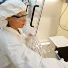Kari Cooper in clean lab, wearing personal protective equipment