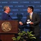 Acting Chancellor Ralph J. Hexter, left, welcomes Director of Athletics Kevin Blue at May 17 news conference.