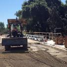 Construction workers grading dirt on the La Rue Road bridge.
