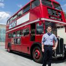 Photo: Lars Reed stands in front of one of Unitrans' historic double-decker buses.