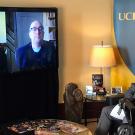 Chancellor Gary S. May filming a video chat with two other men.