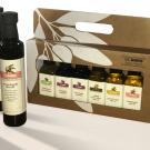 Four bottles of olive oil, displayed with deluxe sampler of six bottles in box