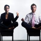 Photo: Employees meditate in chairs at work.