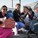Volunteers give Holiday Pet Basket to man and his dog.