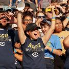 Members of the Aggie Pack cheer at Homecoming 2018.